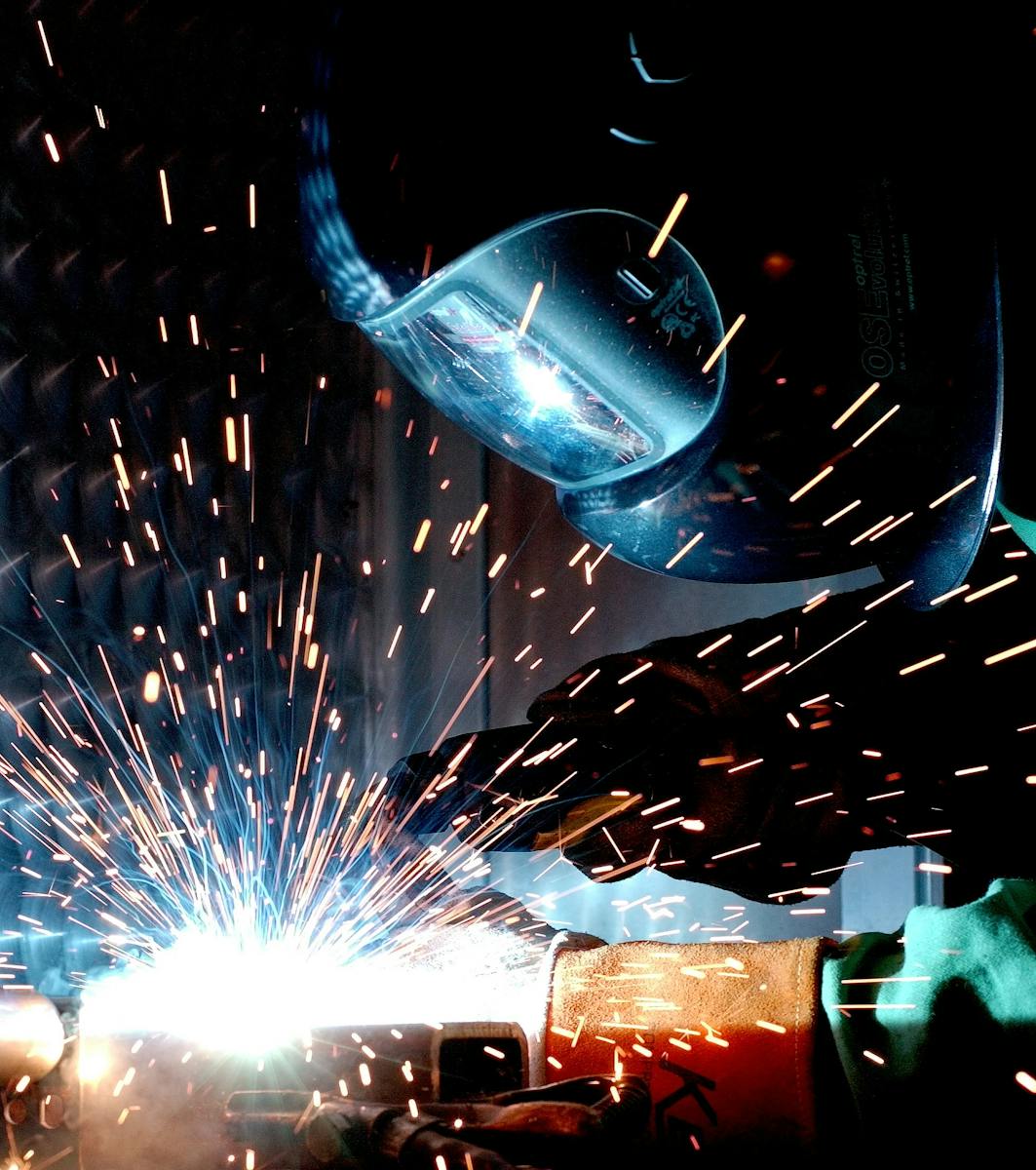 Person in Welding Mask While Welding a Metal Bar, workers